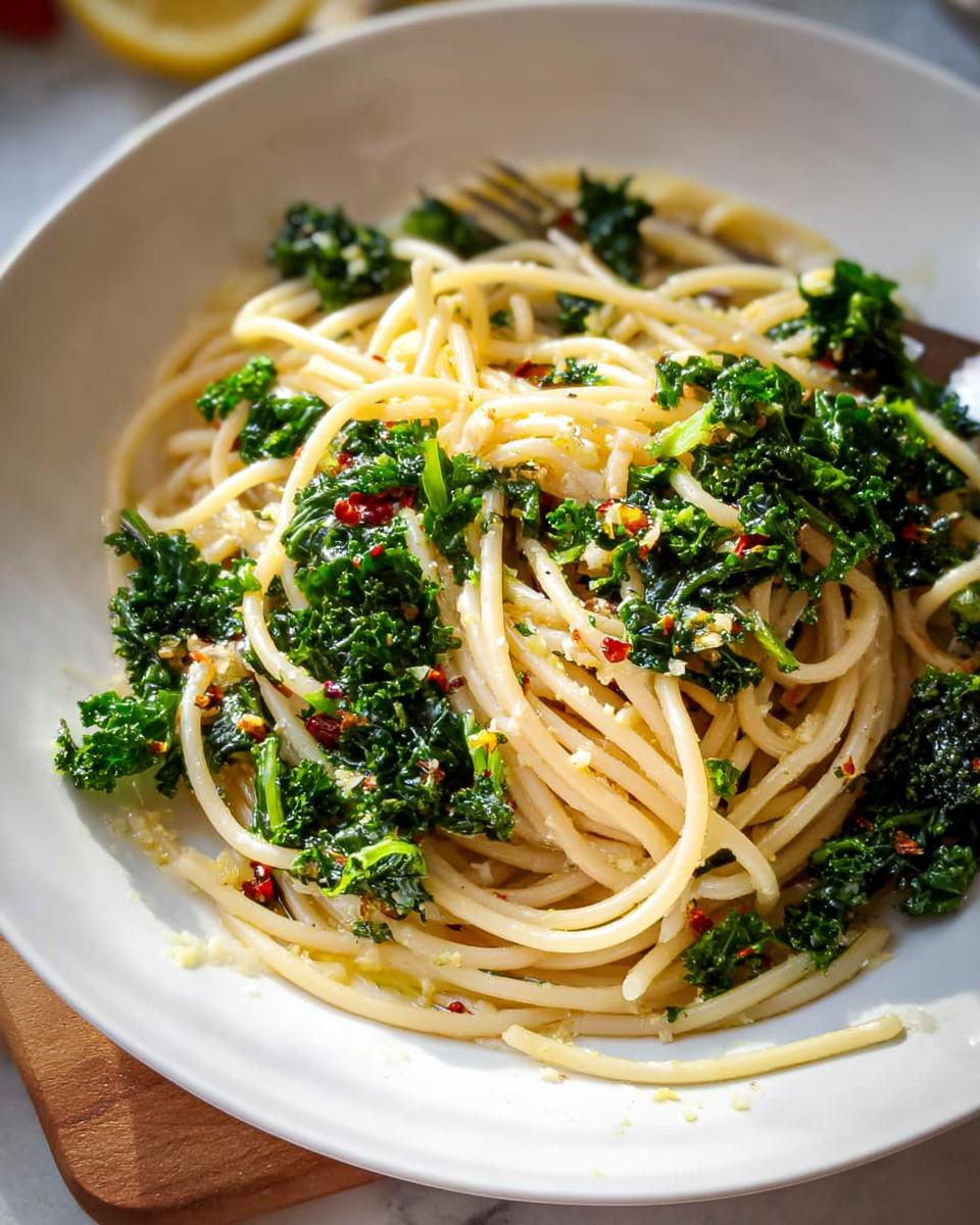 A close-up of spaghetti tossed with chopped kale, garlic, and red chili flakes, a perfect example of easy dinner recipes with bold flavor.