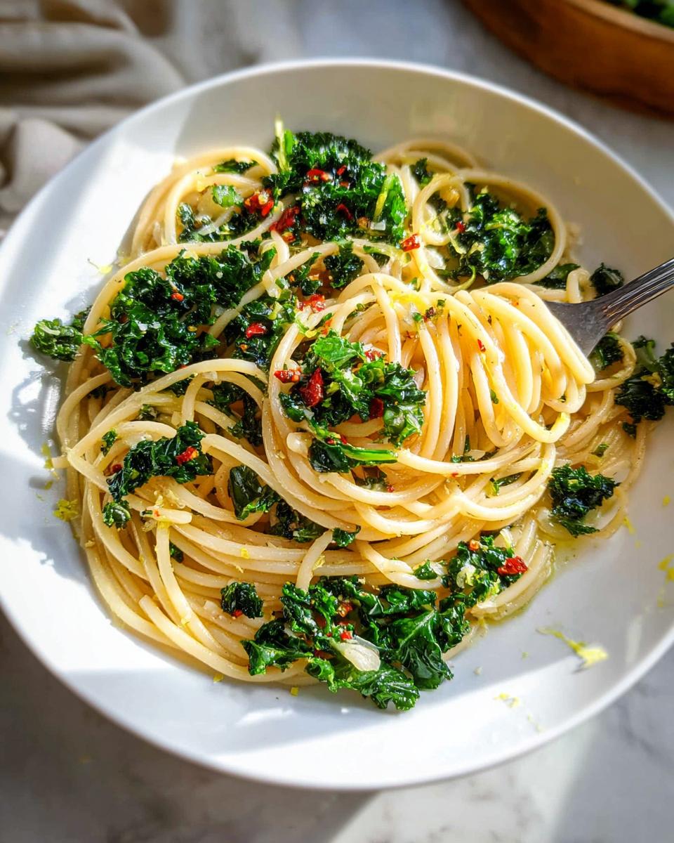 Close-up of spaghetti tossed with kale, chili flakes, and lemon zest, a perfect addition to easy dinner recipes.